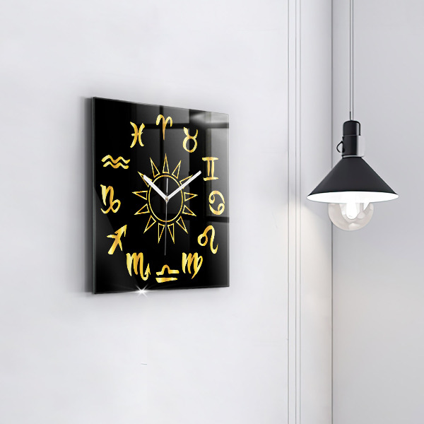 Skleněné nástěnné hodiny Zlatá astrologická znamení na černém pozadí.