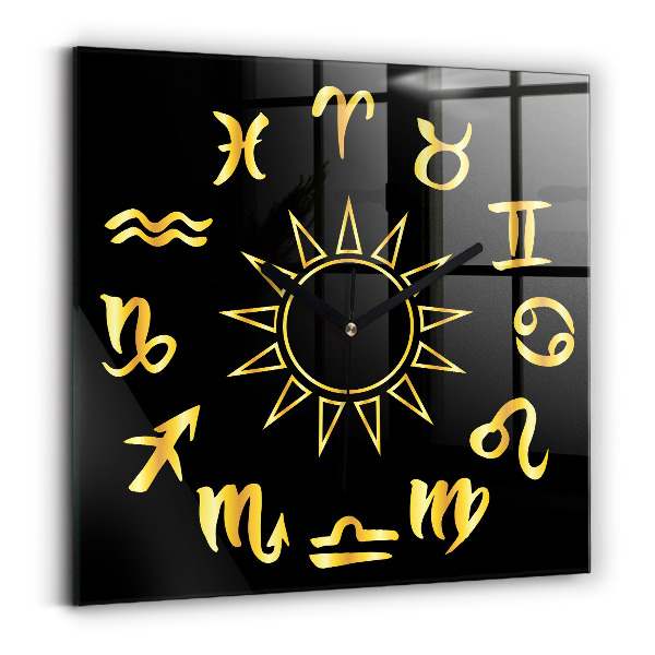 Skleněné nástěnné hodiny Zlatá astrologická znamení na černém pozadí.