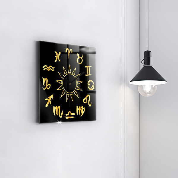 Skleněné nástěnné hodiny Zlatá astrologická znamení na černém pozadí.